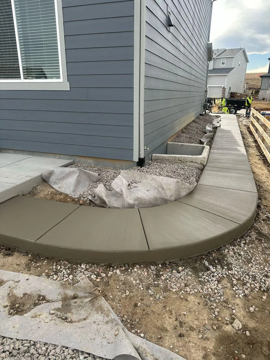 Curved concrete walkway along the house